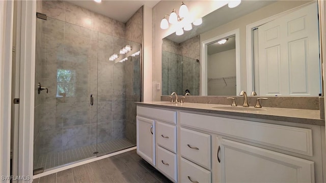 986 Enbrook Loop, Naples, FL 34114 - bathroom featuring a stall shower, double vanity, and a walk in closet