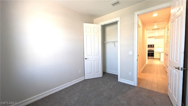 986 Enbrook Loop, Naples, FL 34114 - unfurnished bedroom featuring a closet, baseboards, and carpet flooring