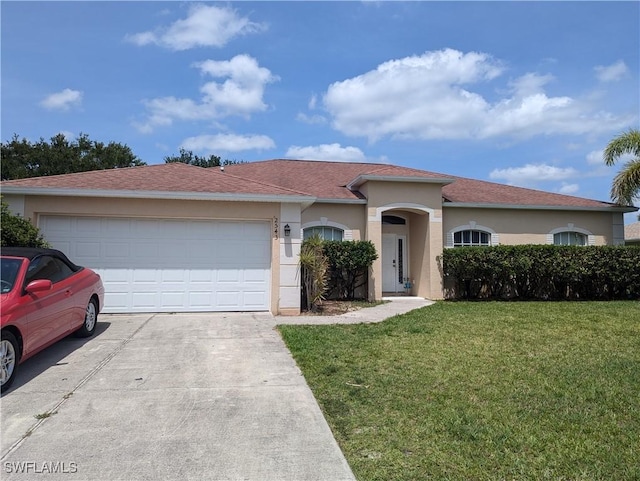 2543 Nature Pointe Loop, Fort Myers, FL 33905 - mediterranean / spanish-style house featuring concrete driveway, a front lawn, an attached garage, and stucco siding