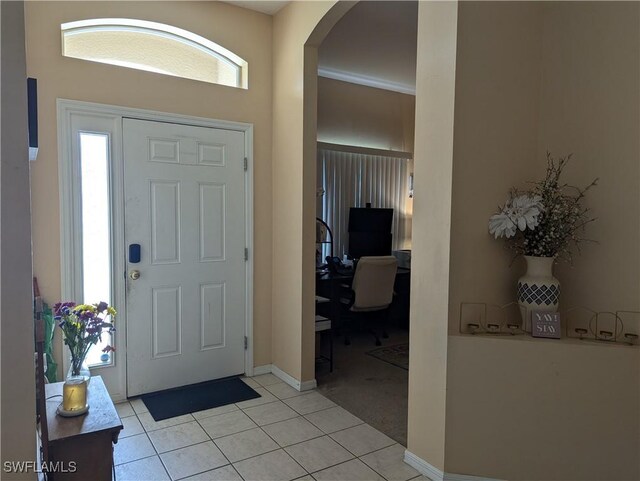 2543 Nature Pointe Loop, Fort Myers, FL 33905 - entryway with arched walkways, light tile patterned floors, healthy amount of natural light, and baseboards