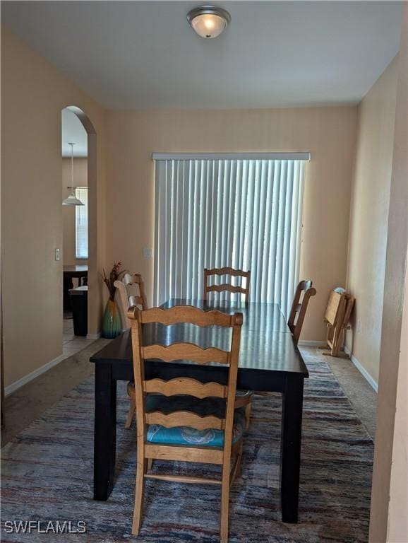 2543 Nature Pointe Loop, Fort Myers, FL 33905 - dining space with arched walkways, carpet flooring, and baseboards