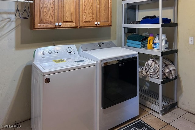 7384 Coon Rd, North Fort Myers, FL 33917 - clothes washing area with washing machine and clothes dryer, cabinet space, and light tile patterned flooring