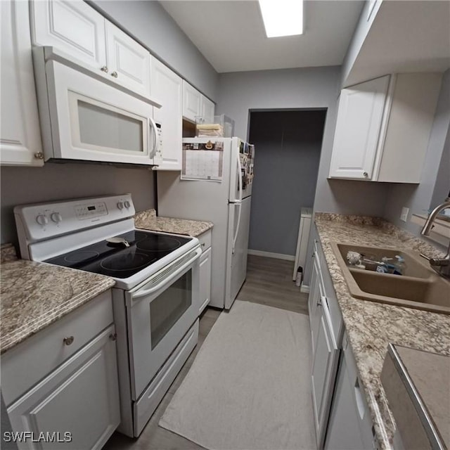 2925 Winkler Ave Unit 906, Fort Myers, FL 33916 - kitchen with white appliances, a sink, and white cabinets