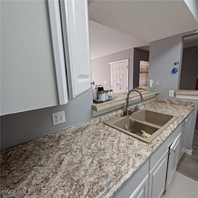 2925 Winkler Ave Unit 906, Fort Myers, FL 33916 - kitchen featuring a sink and light stone countertops