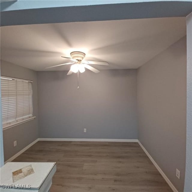 2925 Winkler Ave Unit 906, Fort Myers, FL 33916 - spare room with wood finished floors, a ceiling fan, and baseboards
