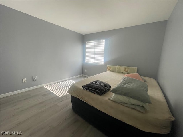 2925 Winkler Ave Unit 906, Fort Myers, FL 33916 - bedroom with wood finished floors and baseboards
