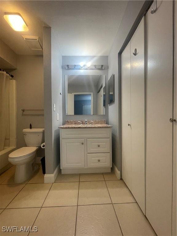 2925 Winkler Ave Unit 906, Fort Myers, FL 33916 - full bath featuring tile patterned flooring, toilet, vanity, and baseboards