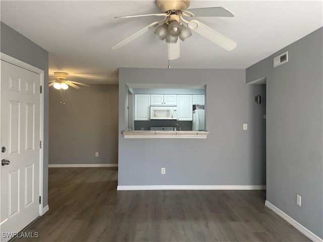 2925 Winkler Ave Unit 906, Fort Myers, FL 33916 - unfurnished living room featuring a ceiling fan, baseboards, and dark wood-type flooring