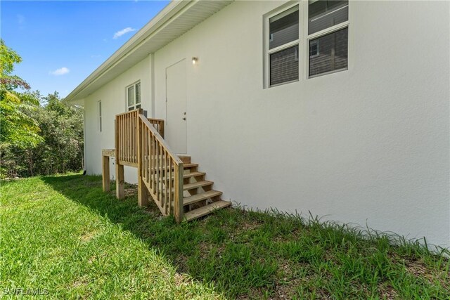 1923 Sheffield Ave, Marco Island, FL 34145 - view of property exterior featuring a yard and stucco siding