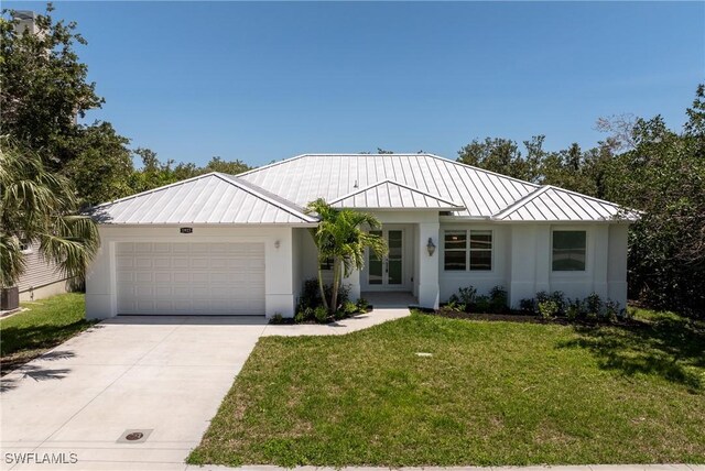1923 Sheffield Ave, Marco Island, FL 34145 - ranch-style house featuring a standing seam roof, french doors, a garage, metal roof, and concrete driveway