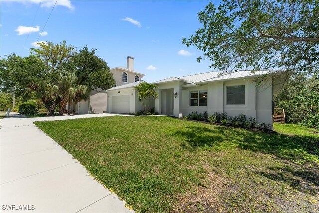 1923 Sheffield Ave, Marco Island, FL 34145 - view of front of home featuring driveway, a garage, a front lawn, and stucco siding