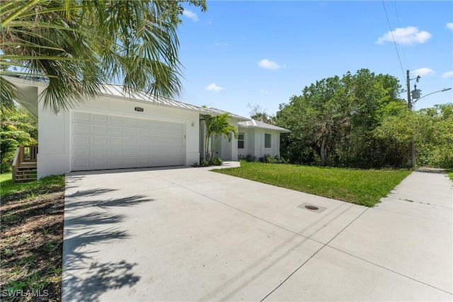 1923 Sheffield Ave, Marco Island, FL 34145 - view of front of house featuring concrete driveway, a front lawn, stucco siding, and a garage