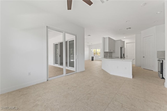 1923 Sheffield Ave, Marco Island, FL 34145 - unfurnished living room with a ceiling fan and baseboards