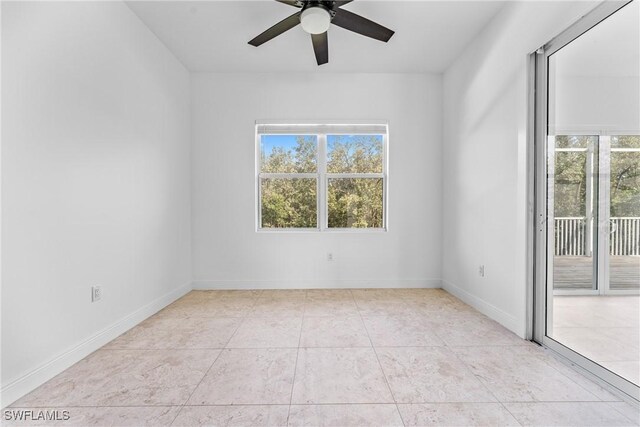 1923 Sheffield Ave, Marco Island, FL 34145 - unfurnished room with plenty of natural light, ceiling fan, light tile patterned floors, and baseboards