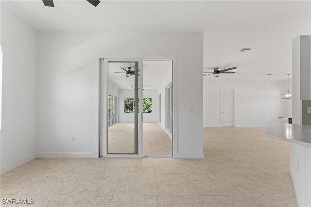 1923 Sheffield Ave, Marco Island, FL 34145 - unfurnished room with a ceiling fan, light tile patterned flooring, and baseboards