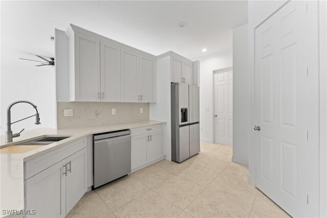 1923 Sheffield Ave, Marco Island, FL 34145 - kitchen with refrigerator with ice dispenser, stainless steel dishwasher, a sink, light countertops, and light tile patterned floors