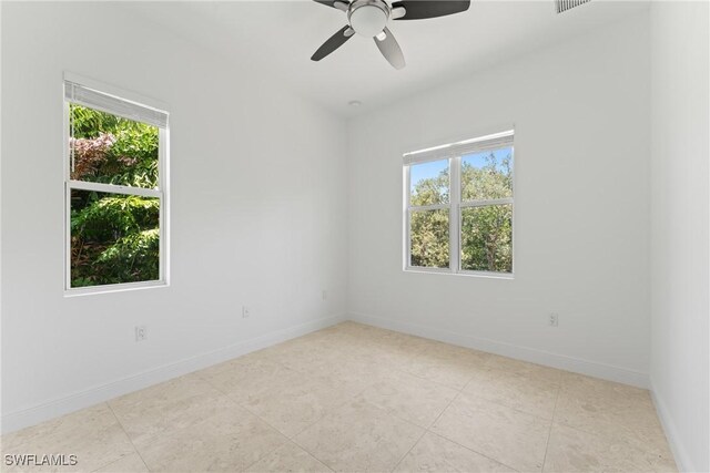 1923 Sheffield Ave, Marco Island, FL 34145 - empty room with healthy amount of natural light, ceiling fan, baseboards, and tile patterned floors