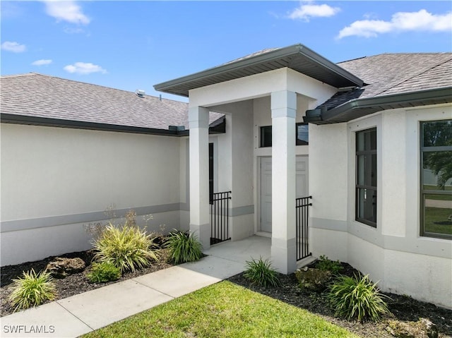 2208 SW 12th Ln, Cape Coral, FL 33991 - doorway to property with stucco siding and a shingled roof