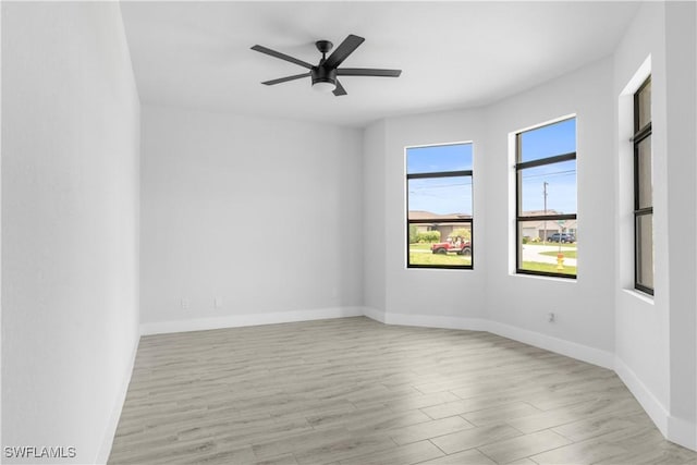 2208 SW 12th Ln, Cape Coral, FL 33991 - empty room with light wood-style flooring, baseboards, and ceiling fan