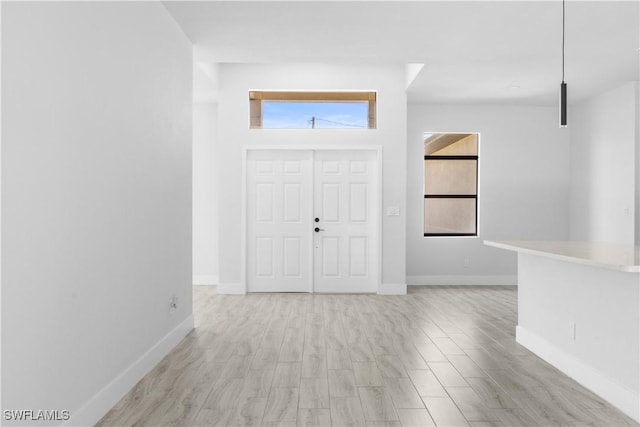 2208 SW 12th Ln, Cape Coral, FL 33991 - entryway featuring baseboards and light wood finished floors