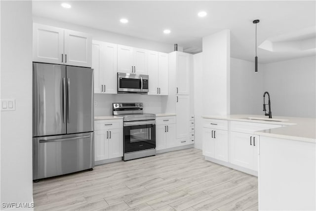 2208 SW 12th Ln, Cape Coral, FL 33991 - kitchen with appliances with stainless steel finishes, a sink, light countertops, recessed lighting, and white cabinets
