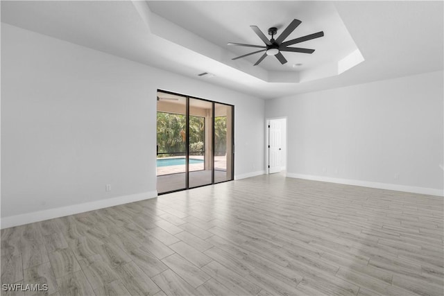 2208 SW 12th Ln, Cape Coral, FL 33991 - unfurnished room featuring a raised ceiling, a ceiling fan, and baseboards