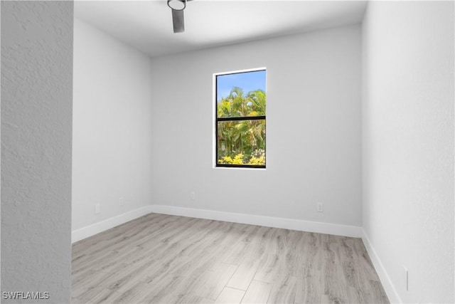 2208 SW 12th Ln, Cape Coral, FL 33991 - empty room featuring wood finished floors and baseboards