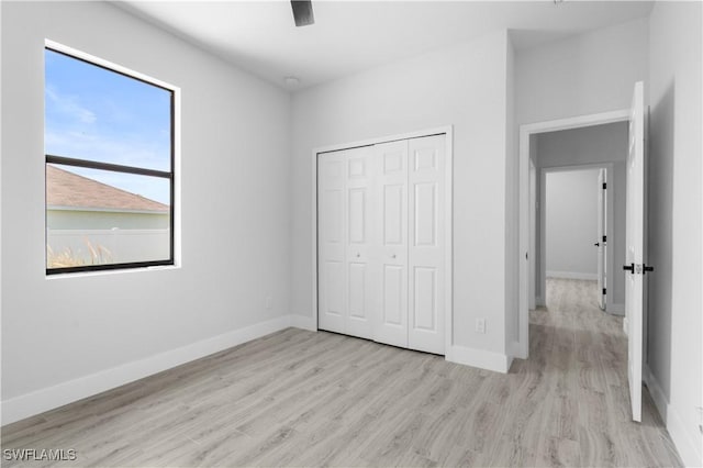 2208 SW 12th Ln, Cape Coral, FL 33991 - unfurnished bedroom featuring wood finished floors, a closet, and baseboards