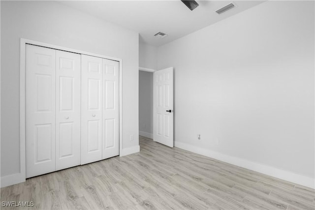 2208 SW 12th Ln, Cape Coral, FL 33991 - unfurnished bedroom featuring wood finished floors, a closet, and baseboards
