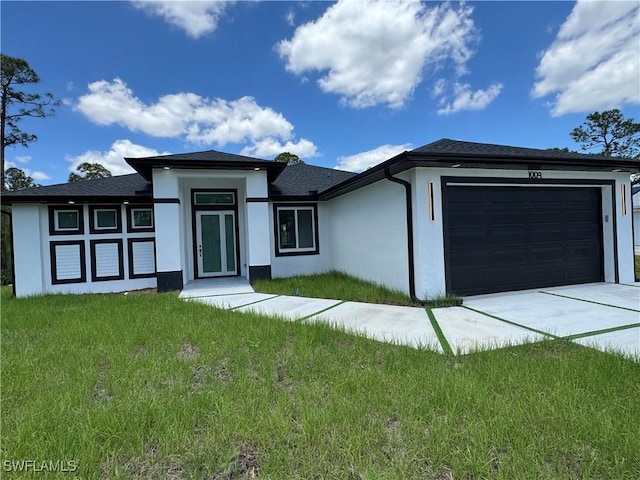 1010 Euclid Ave, Lehigh Acres, FL 33972 - prairie-style house featuring stucco siding, an attached garage, a front yard, and driveway