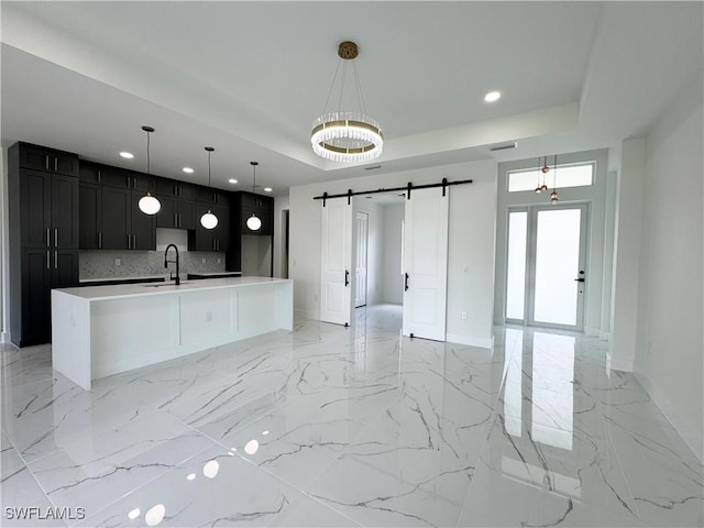 1010 Euclid Ave, Lehigh Acres, FL 33972 - kitchen featuring a barn door, recessed lighting, baseboards, and light marble finish flooring