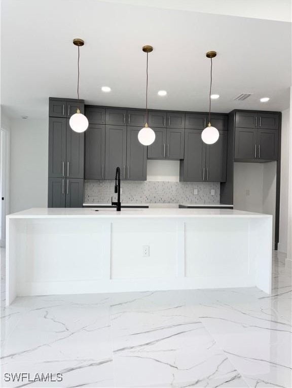 1010 Euclid Ave, Lehigh Acres, FL 33972 - kitchen with a sink, decorative backsplash, decorative light fixtures, a kitchen island with sink, and recessed lighting
