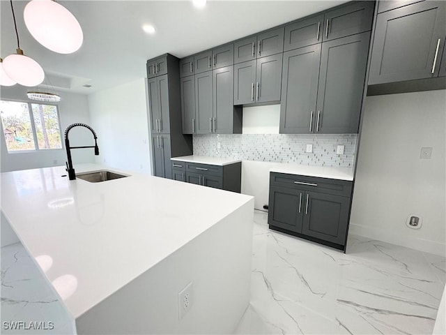 1010 Euclid Ave, Lehigh Acres, FL 33972 - kitchen with a sink, light marble finish floors, tasteful backsplash, recessed lighting, and baseboards