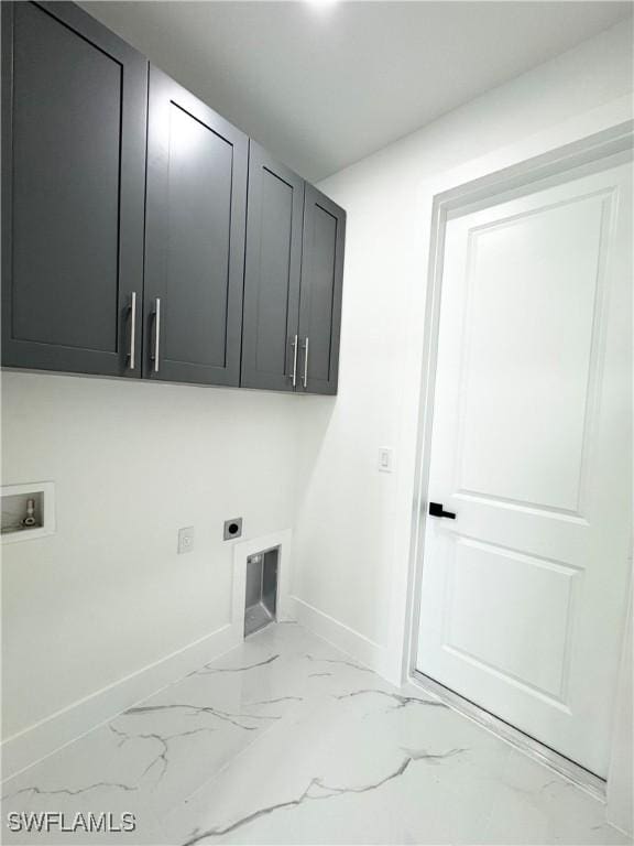 1010 Euclid Ave, Lehigh Acres, FL 33972 - clothes washing area with cabinet space, hookup for an electric dryer, light marble finish flooring, washer hookup, and baseboards