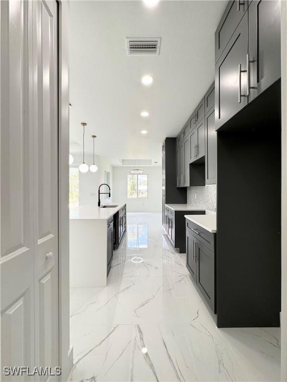 1010 Euclid Ave, Lehigh Acres, FL 33972 - kitchen with light marble finish flooring, a sink, tasteful backsplash, dishwasher, and recessed lighting