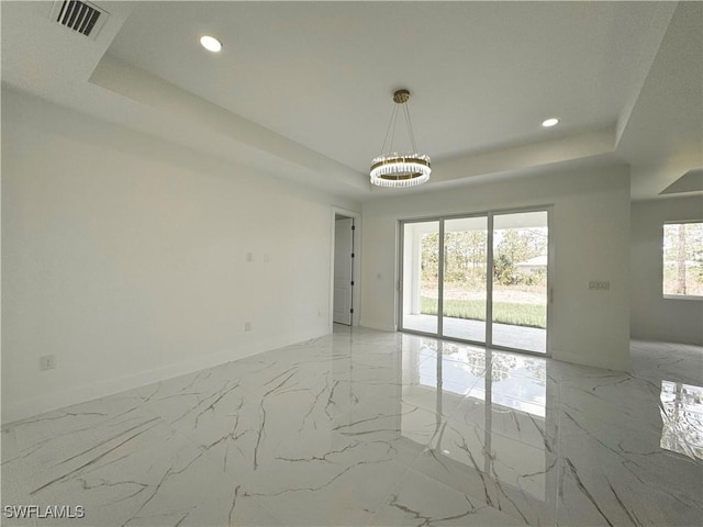 1010 Euclid Ave, Lehigh Acres, FL 33972 - unfurnished room with a tray ceiling, a chandelier, light marble finish flooring, and recessed lighting