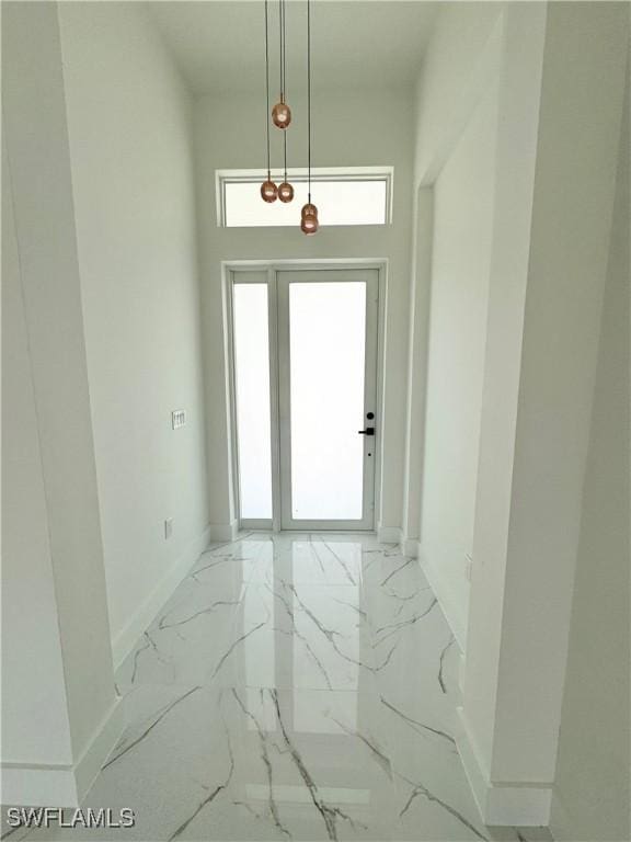 1010 Euclid Ave, Lehigh Acres, FL 33972 - entryway featuring light marble finish flooring and baseboards