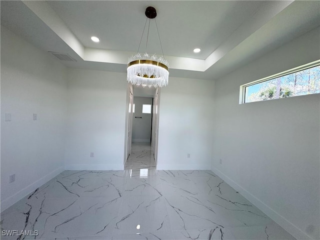 1010 Euclid Ave, Lehigh Acres, FL 33972 - unfurnished room featuring a chandelier, a tray ceiling, baseboards, recessed lighting, and marble finish floors