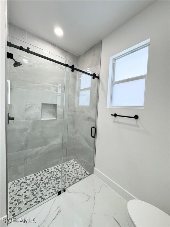 1010 Euclid Ave, Lehigh Acres, FL 33972 - full bathroom with baseboards, marble finish flooring, a shower stall, toilet, and recessed lighting