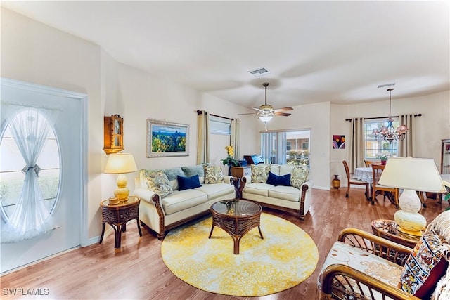 19977 Lake Vista Cir Unit 17A, Lehigh Acres, FL 33936 - living room with light wood-type flooring, a chandelier, ceiling fan, and baseboards