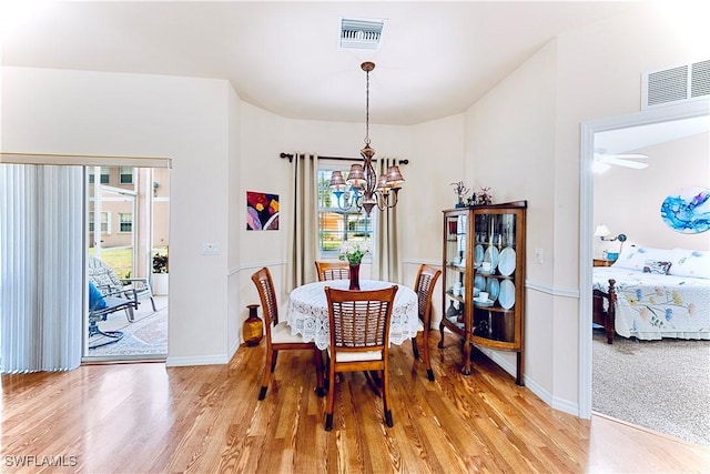 19977 Lake Vista Cir Unit 17A, Lehigh Acres, FL 33936 - dining room with a chandelier, healthy amount of natural light, light wood-type flooring, and baseboards