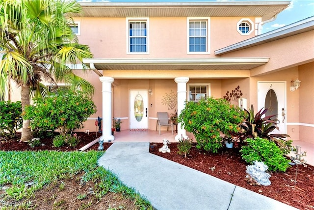 19977 Lake Vista Cir Unit 17A, Lehigh Acres, FL 33936 - property entrance with covered porch and stucco siding
