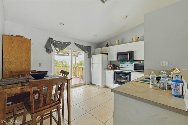573 Pachman Cir, Lehigh Acres, FL 33974 - kitchen featuring white appliances, light tile patterned floors, light countertops, white cabinets, and lofted ceiling