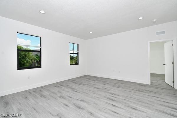 8304 Lena Ct, Labelle, FL 33935 - empty room with light wood-style flooring, recessed lighting, and baseboards
