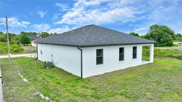 7071 Tide Cir, Labelle, FL 33935 - view of home's exterior featuring a yard, a shingled roof, and stucco siding