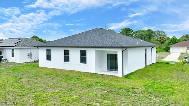7071 Tide Cir, Labelle, FL 33935 - rear view of house featuring stucco siding, a lawn, and a shingled roof
