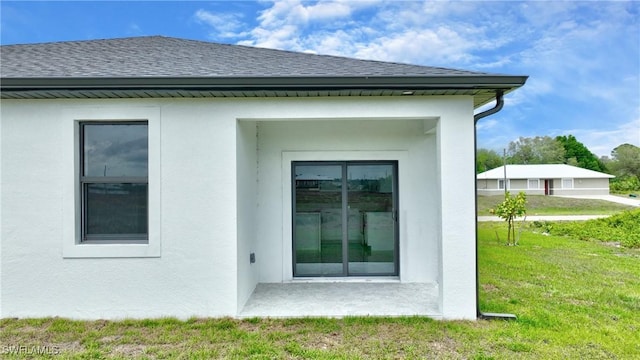 7071 Tide Cir, Labelle, FL 33935 - view of property exterior with roof with shingles, a lawn, and stucco siding