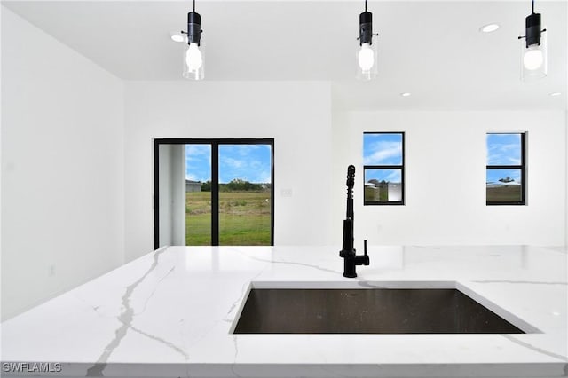 7071 Tide Cir, Labelle, FL 33935 - kitchen featuring a sink, light stone counters, decorative light fixtures, recessed lighting, and open floor plan