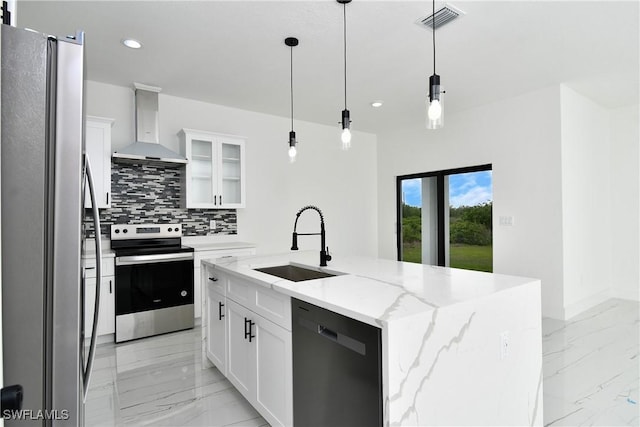 7071 Tide Cir, Labelle, FL 33935 - kitchen featuring appliances with stainless steel finishes, wall chimney exhaust hood, a sink, light marble finish flooring, and backsplash