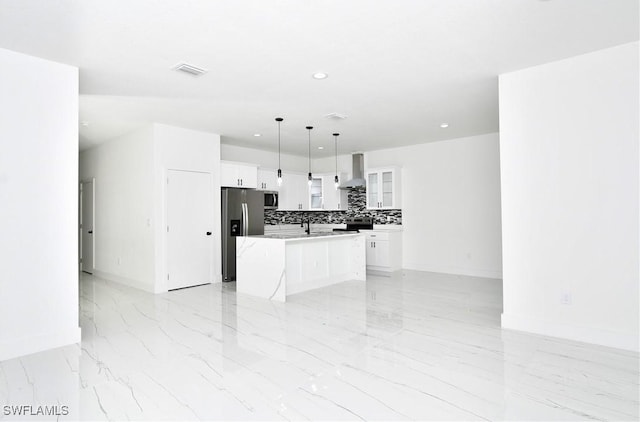 7071 Tide Cir, Labelle, FL 33935 - kitchen with stainless steel appliances, wall chimney range hood, backsplash, light countertops, and white cabinets